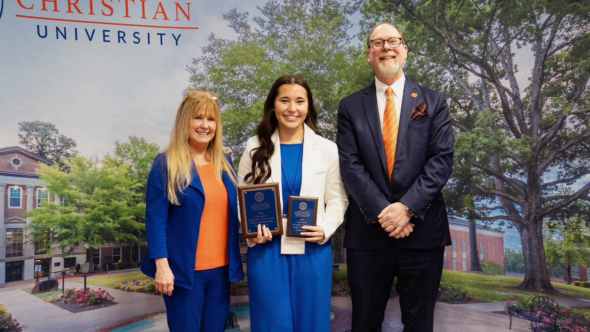 Smiling woman with two awards from