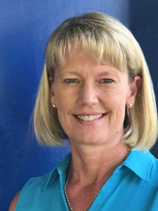 Smiling blonde woman in a turquoise shirt