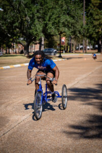 Determined man with dreadlocks rides