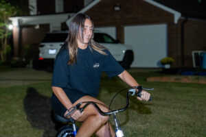 Smiling young woman with long hair riding a
