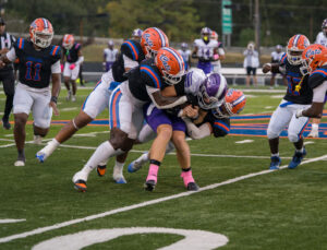 American football players in black and purple