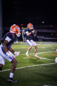 Football player in orange helmet and black jersey