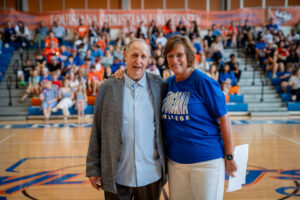 Smiling man and woman in a gymnasium,