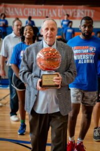 Coach Gene Russ holds The Wildcat