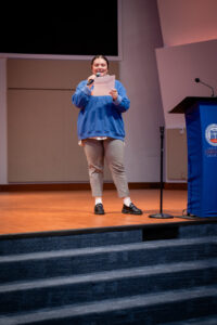 Young woman speaks into microphone