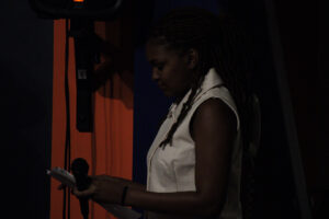 Woman with dreadlocks holding a microphone