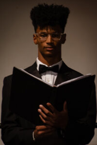 Young man in tuxedo and glasses with