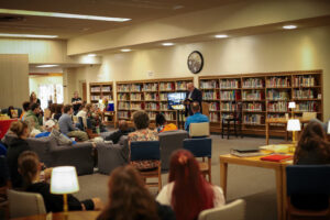 Man reads to an audience in a