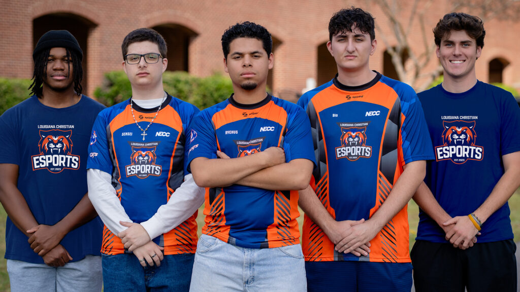LCU Esports team in blue and orange branded jerseys posed in a line.