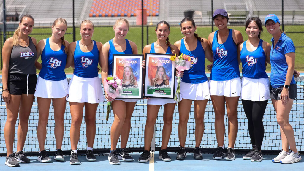 LCU Women's Tennis holding recognition signs during the NAIA Tournament