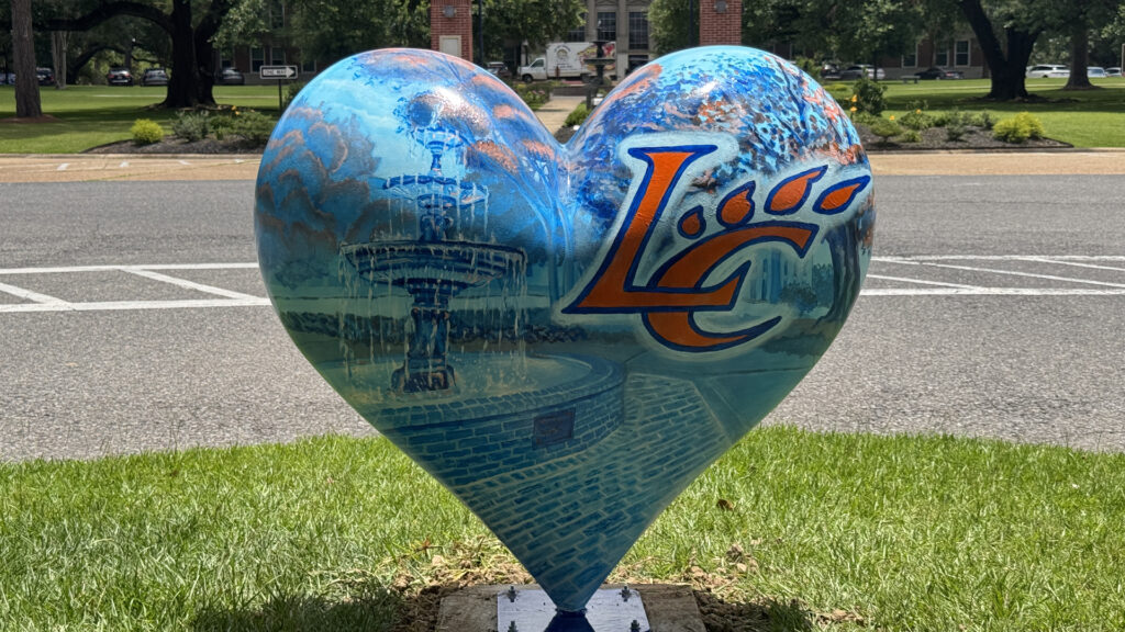 Photo of LCU's community heart featuring a blue and orange duotone style rendition of the Kilgore-Kirkpartic fountain and the LC claw mark logo in the top right hand corner.
