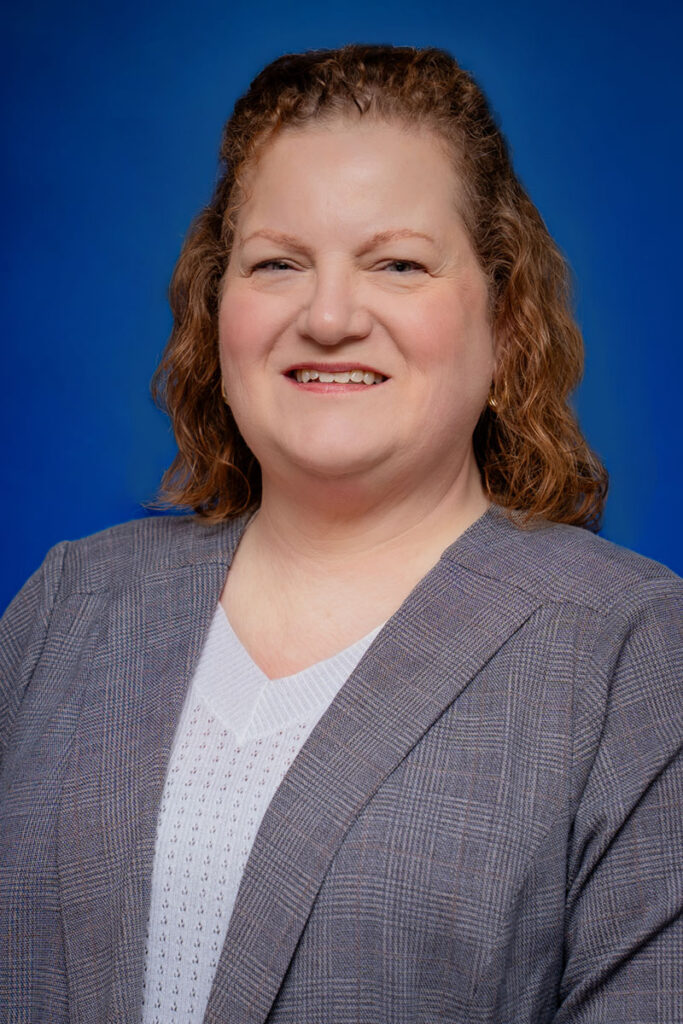 Professional headshot of a smiling woman in
