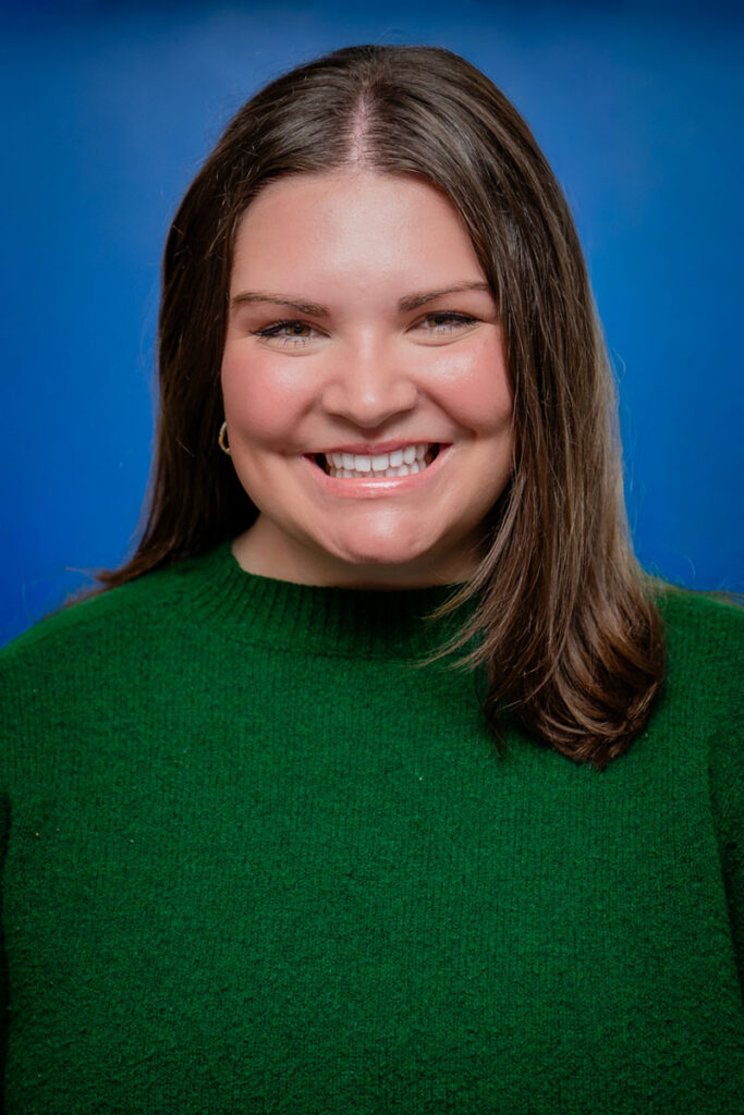 Smiling young woman with brown hair in a