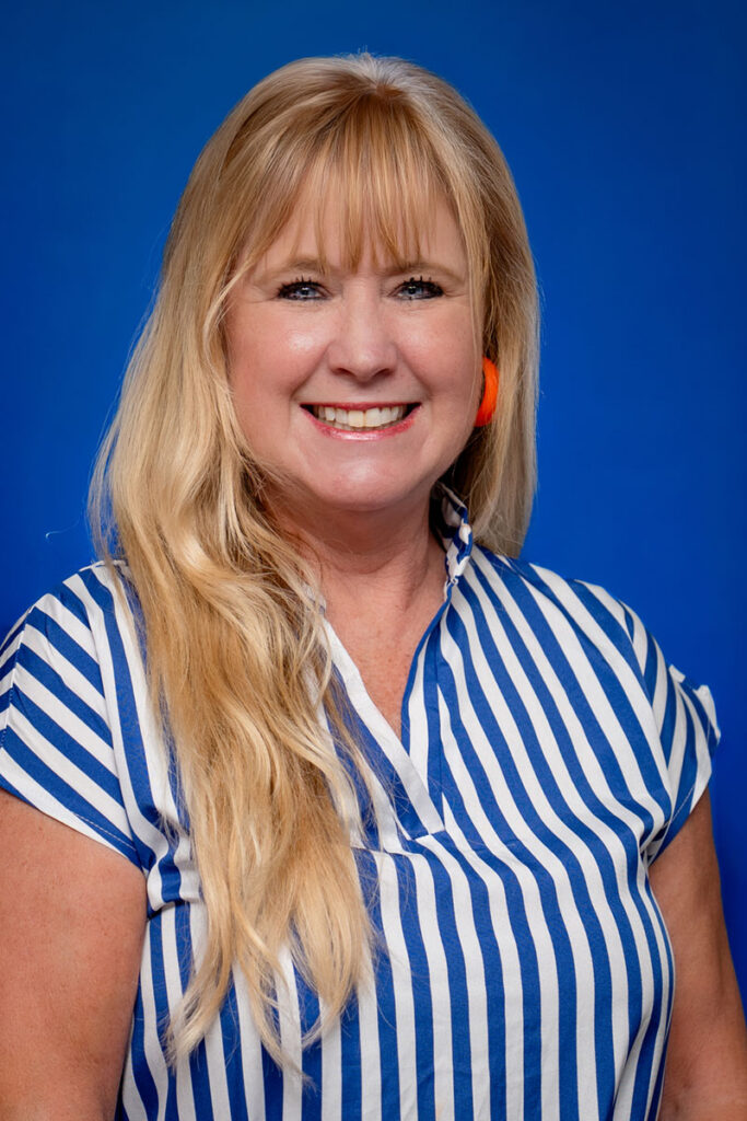 Smiling woman with blonde hair, blue eyes