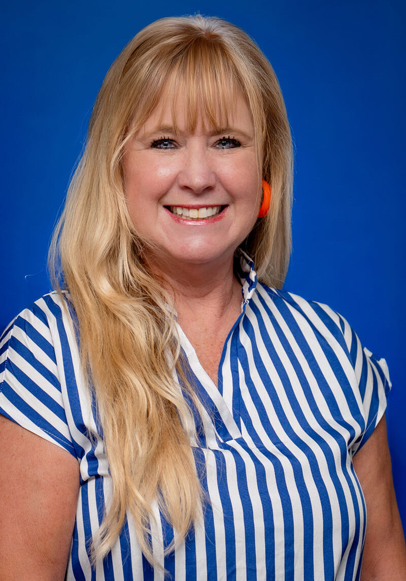 Smiling woman with blonde hair, blue eyes